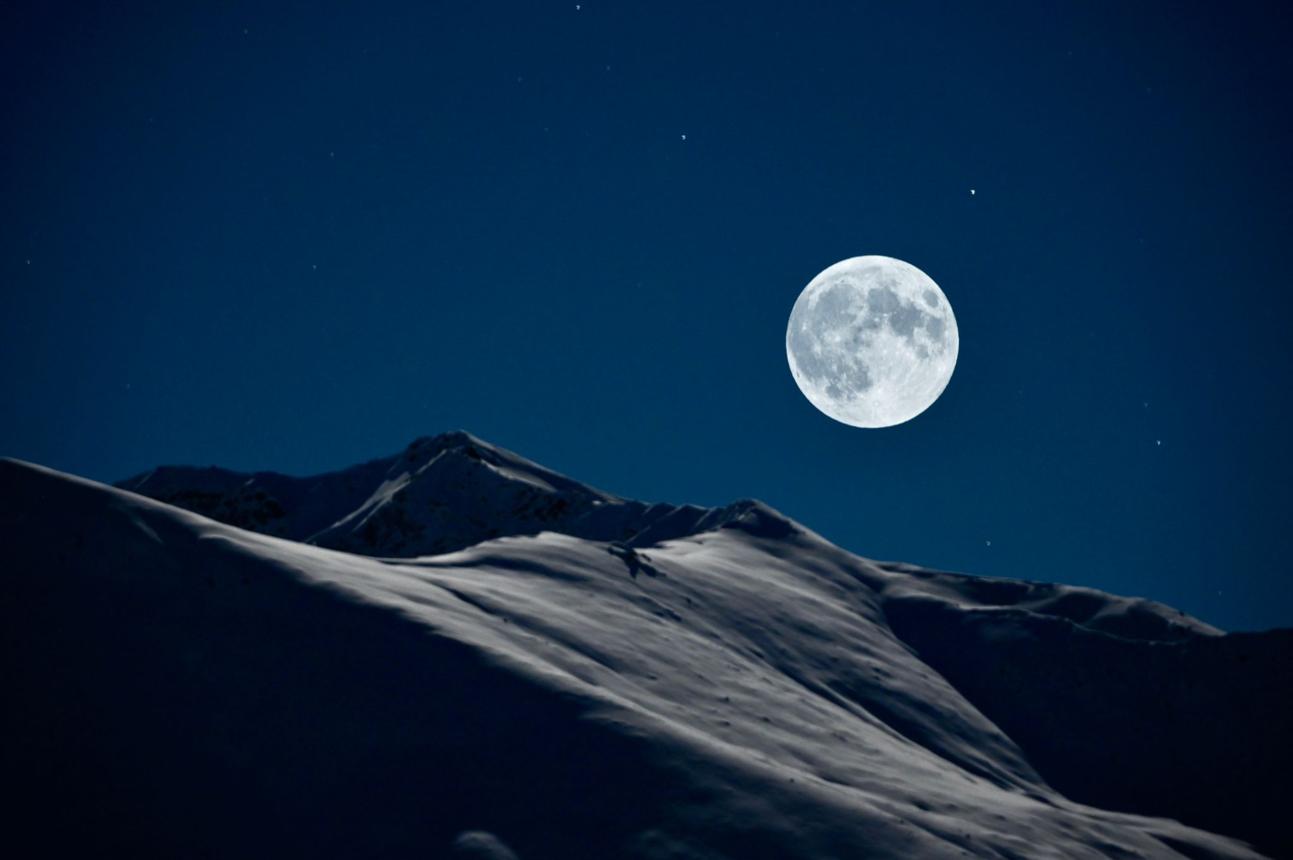 Full moon casting it's glow onto the Talkeetna Mountains in Hatcher Pass Alaska